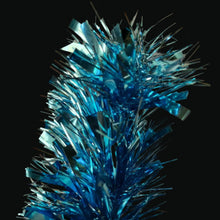 Load image into Gallery viewer, Blue metallic tinsel garland with shiny reflective strips, photographed close-up against a plain warm beige background.