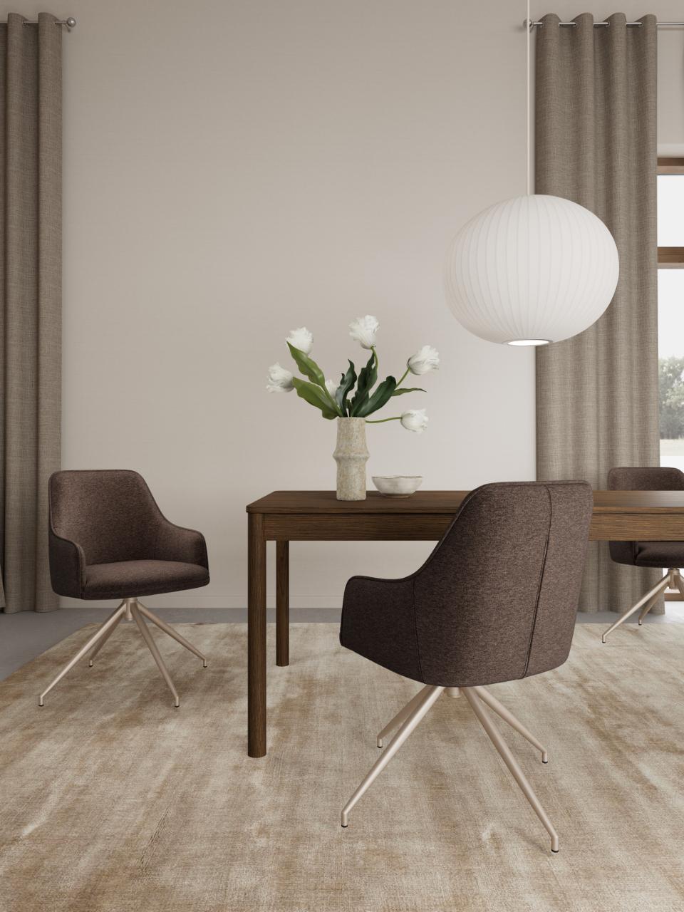 A modern dining room scene featuring a dark brown wooden table and upholstered dining chairs with a white spherical pendant light and beige curtains.