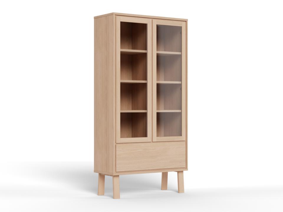 A tall light oak wood display cabinet with two glass doors, four interior shelves, and a lower drawer, shown on a white background.