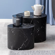 Load image into Gallery viewer, A set of two black marble coffee tables with a unique oval shape, one larger than the other, both with a decorative item on top.