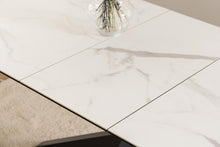 Load image into Gallery viewer, White marble-look extending rectangular table top with gray veining, shown in a close-up of a tabletop with a glass vase on top.