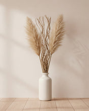 Load image into Gallery viewer, White vase with dried pampas grass on a wooden floor against a beige wall