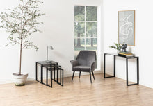 Load image into Gallery viewer, Modern living room with gray armchair, side tables, and decorative elements.