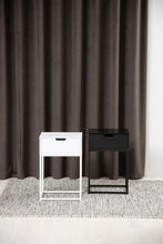 Load image into Gallery viewer, Two side tables, one white and one black, against a brown curtain.