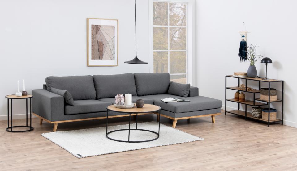 Modern living room with a gray sectional sofa, coffee table, and decorative items.