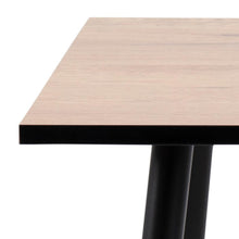 Load image into Gallery viewer, Close-up of a table showing a light natural wood grain tabletop with a black edge and black metal legs on a white background.