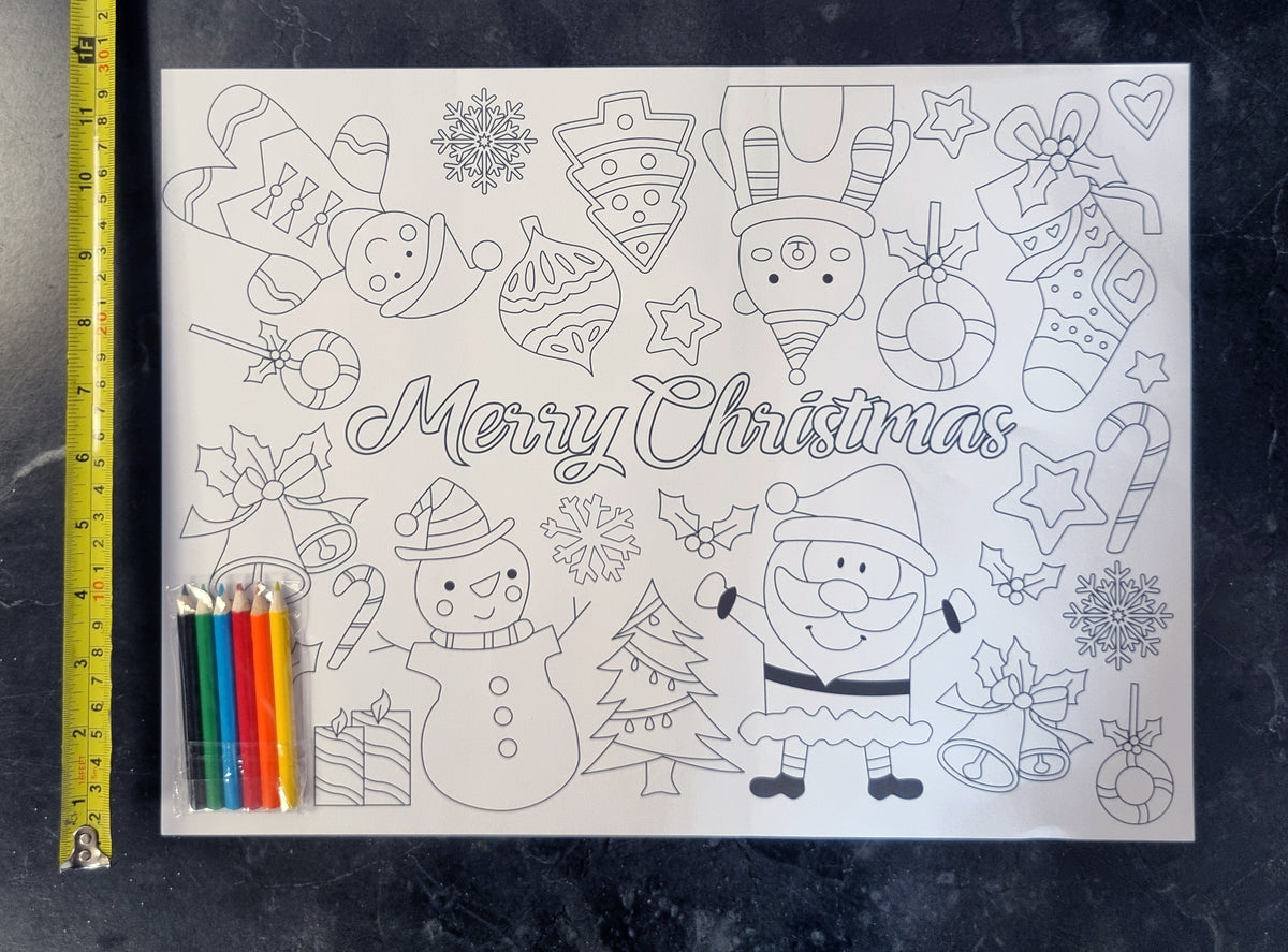 a colour your own placemat with pencils on top next to a a tape measure in yellow showing the height of the placemat to be 30cm
