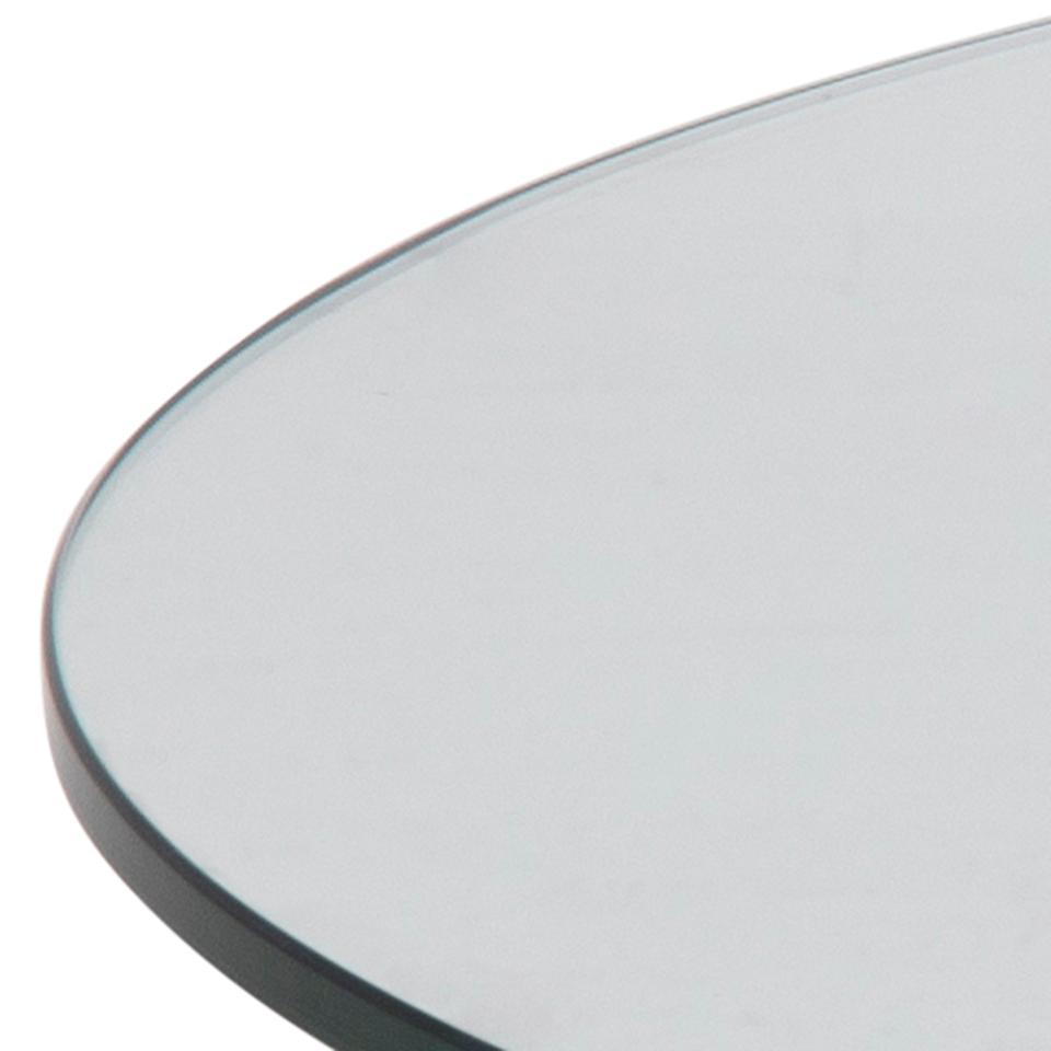 close up of the round clear glass table top of a heaven coffee table on a white background