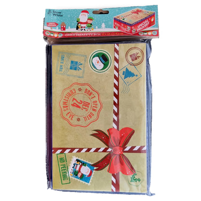 Christmas Eve gift box set in clear plastic packaging with a printed header card. The box is decorated with a beige textured paper look, red and white striped ribbon, a red bow, postage stamp graphics, and festive holiday illustrations including Santa Claus and a snowman.