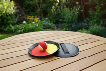 Load image into Gallery viewer, Ping pong ball on a paddle on a wooden table outdoors
