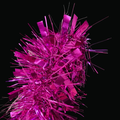 Metallic hot pink tinsel garland with shiny rectangular strips and fine strands, photographed against a plain light gray background.