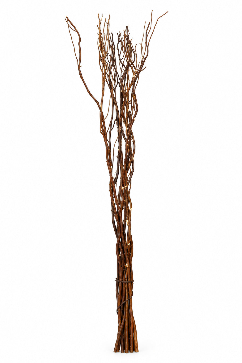 A bundle of artificial brown decorative branches with a twisted, vine-like structure, standing upright against a plain white wall.