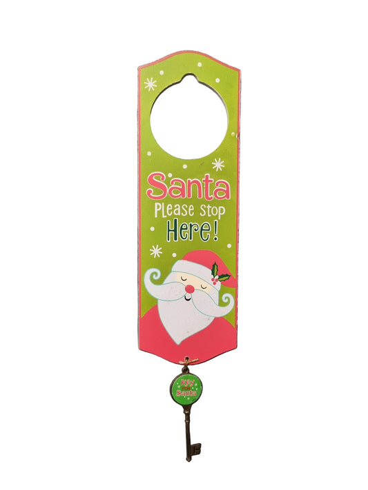 A Christmas-themed door hanger with a hanging key, featuring a colorful Santa graphic and the text 'Santa Please Stop Here!' on a white background.