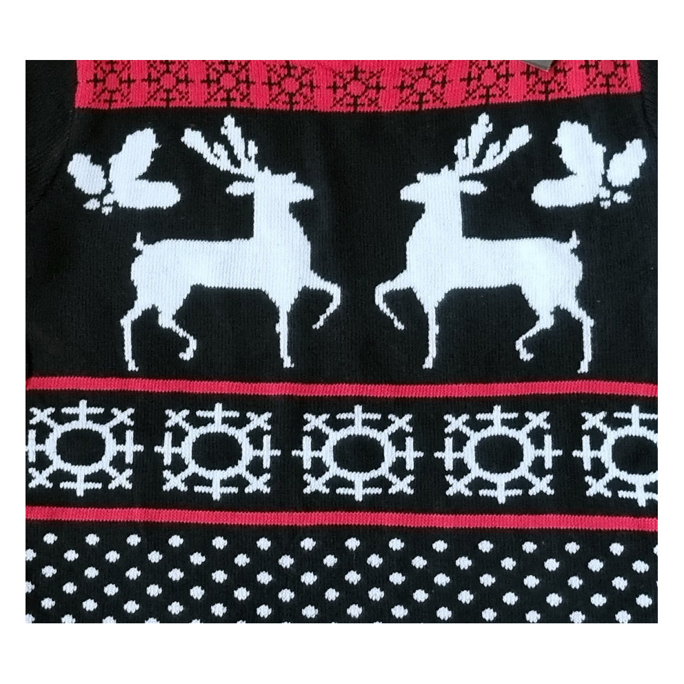 A close-up of a black knit Christmas sweater featuring two white reindeer, white snowflake patterns, and red and white horizontal borders.