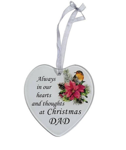 A white heart-shaped glass hanging decoration with a poinsettia flower and a robin, and the text 'Always in our hearts and thoughts at Christmas Dad'.