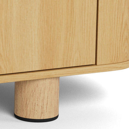 Close-up of a light natural wood cabinet or sideboard with a cylindrical wooden leg and a small black base ring, shown against a white background.