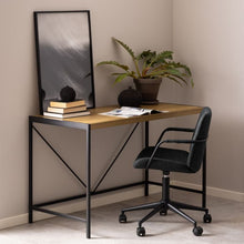 Load image into Gallery viewer, Modern home office desk with black chair, books, and a plant against a neutral wall.
