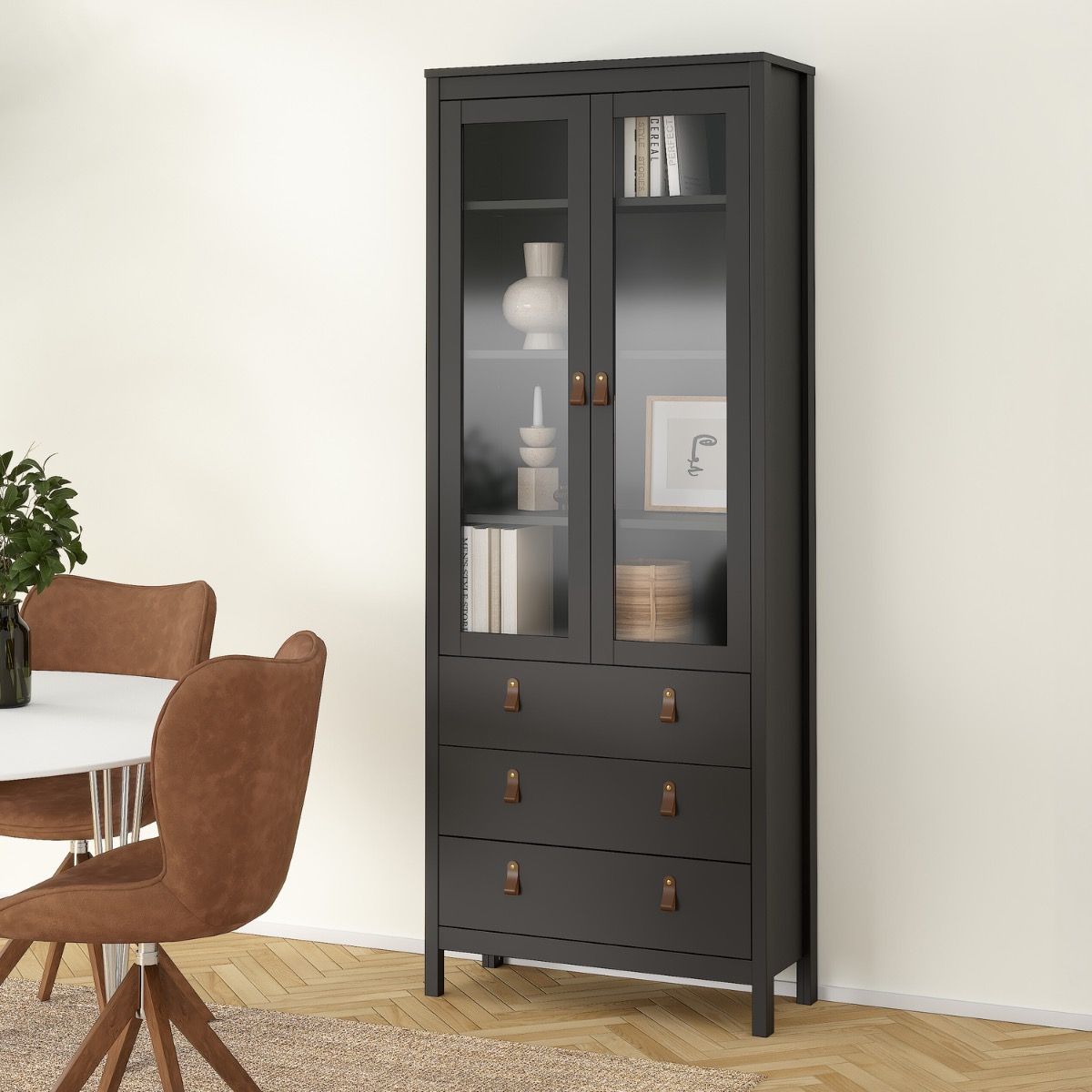 A tall Barcelona black glass-front cabinet with three upper doors and three lower drawers, styled in a dining room next to a table and chairs.