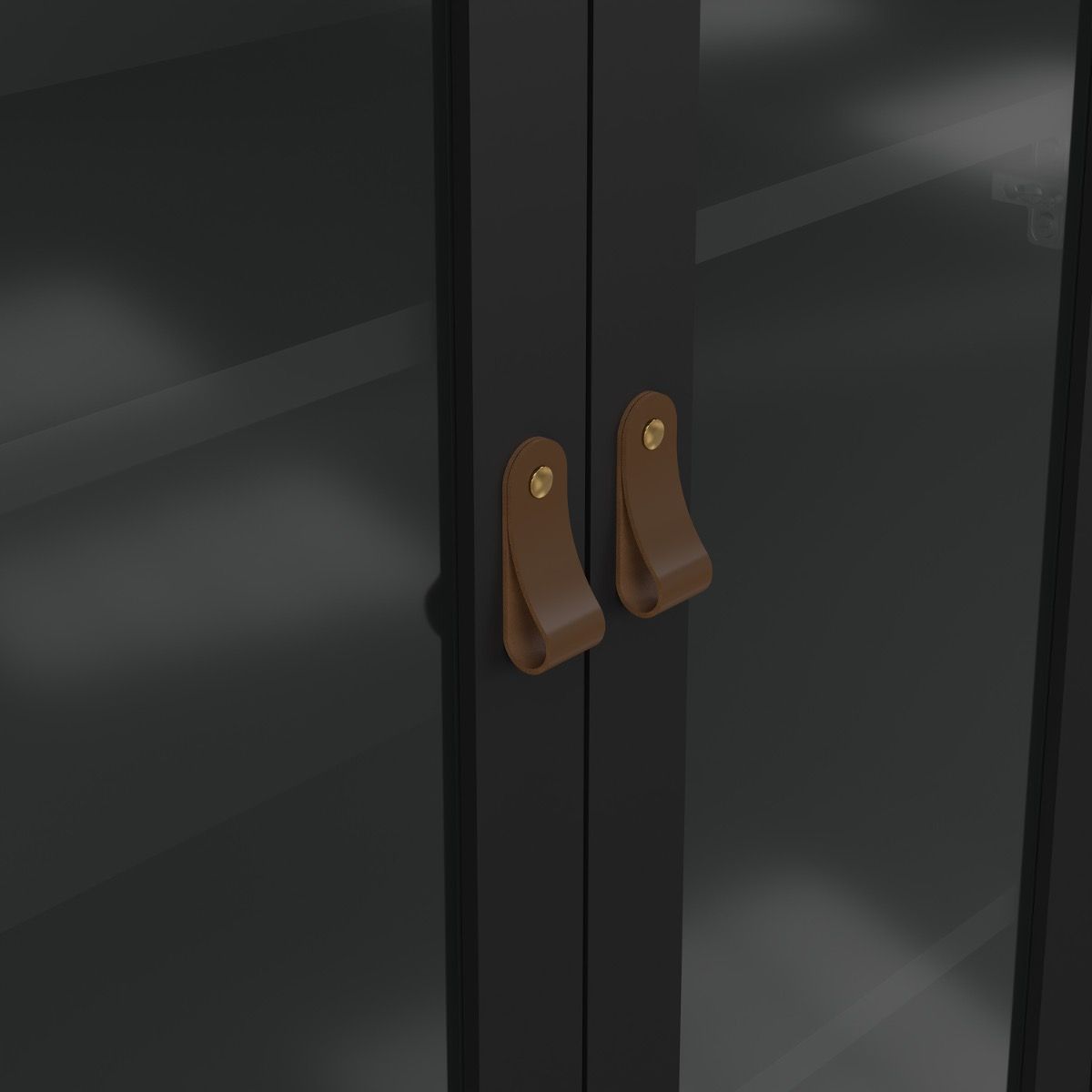 Close-up of a pair of dark charcoal glass cabinet doors with curved brown leather pull handles and small brass screws.