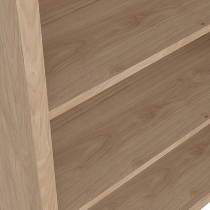 Close up view of an oak bookcase showing the grain of the wooden shelves