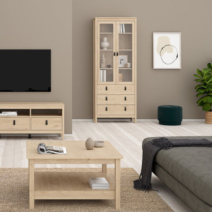 A Barcelona oak wooden storage cabinet against a beige wall in a modern home with matching oak furniture and home accessories