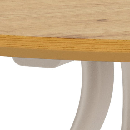 Close-up detail of a table showing a light natural wood top edge with a yellow-orange wood veneer or laminate strip along the front, supported by a curved off-white metal leg on a white background.