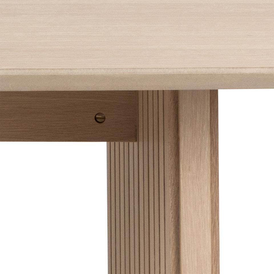 Close-up of a wooden desk with a white background
