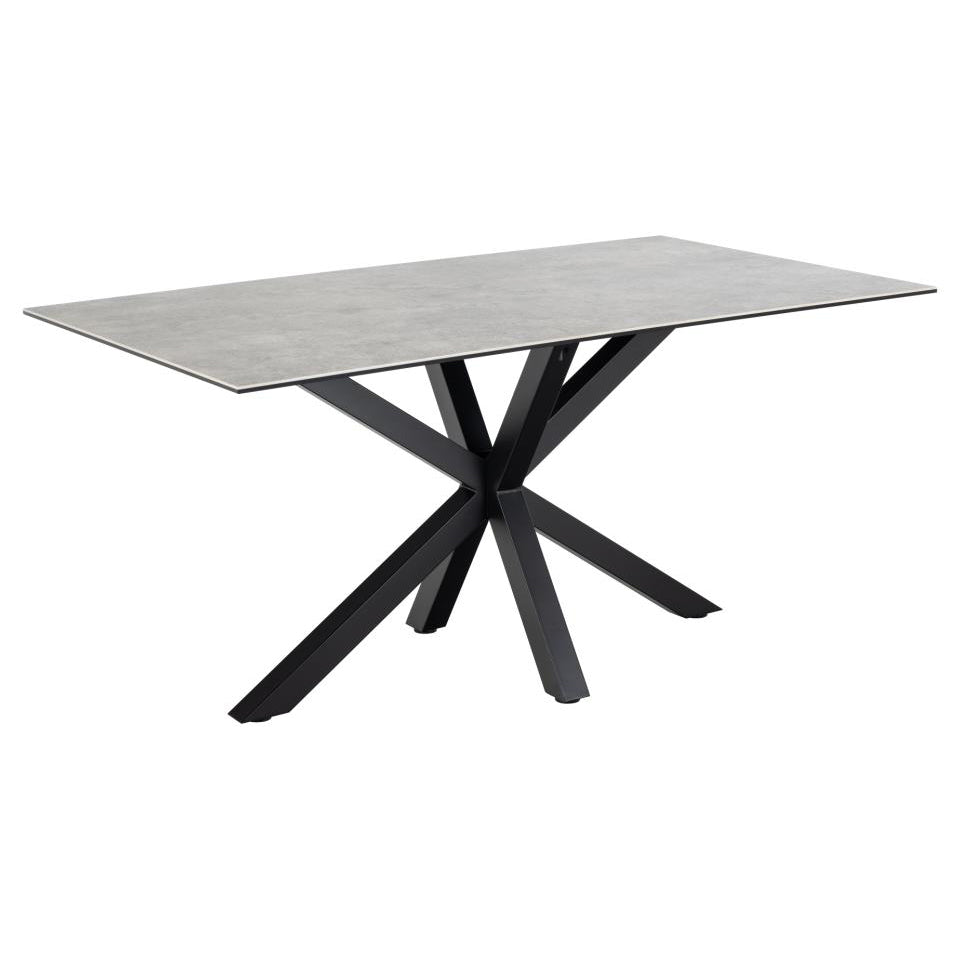 A rectangular ceramic dining table with a grey top and a solid metal base in a cross design, painted in matt black.