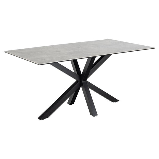 A rectangular ceramic dining table with a grey top and a solid metal base in a cross design, painted in matt black.
