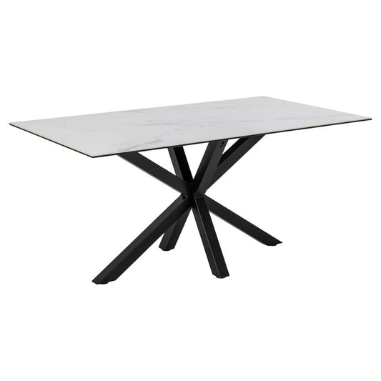 A rectangular white ceramic dining table with a solid black metal cross base.