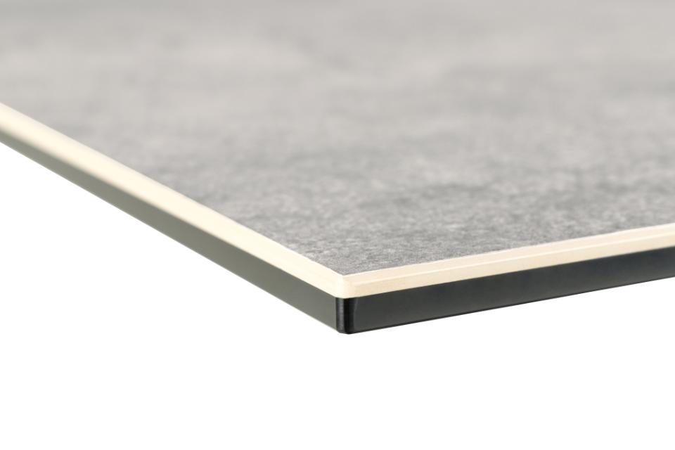 Close-up of a gray ceramic table corner with a white border on a white background