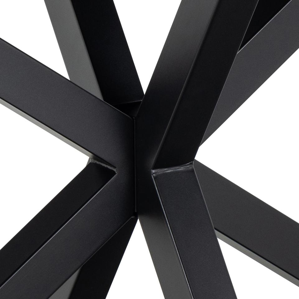 Close-up of a black metal frame with intersecting beams on a white background