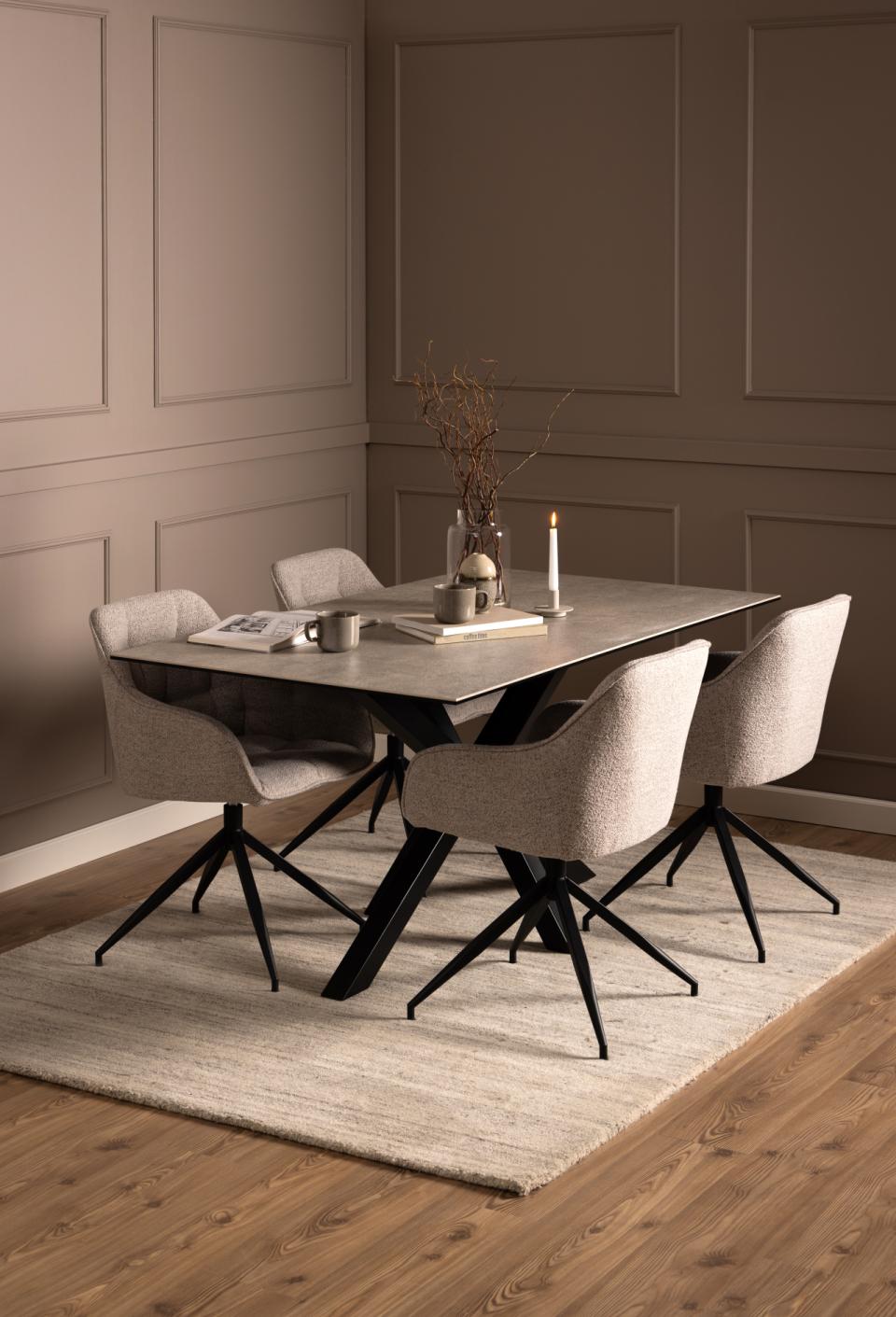Dining room with a table and chairs against a wall with wainscoting.