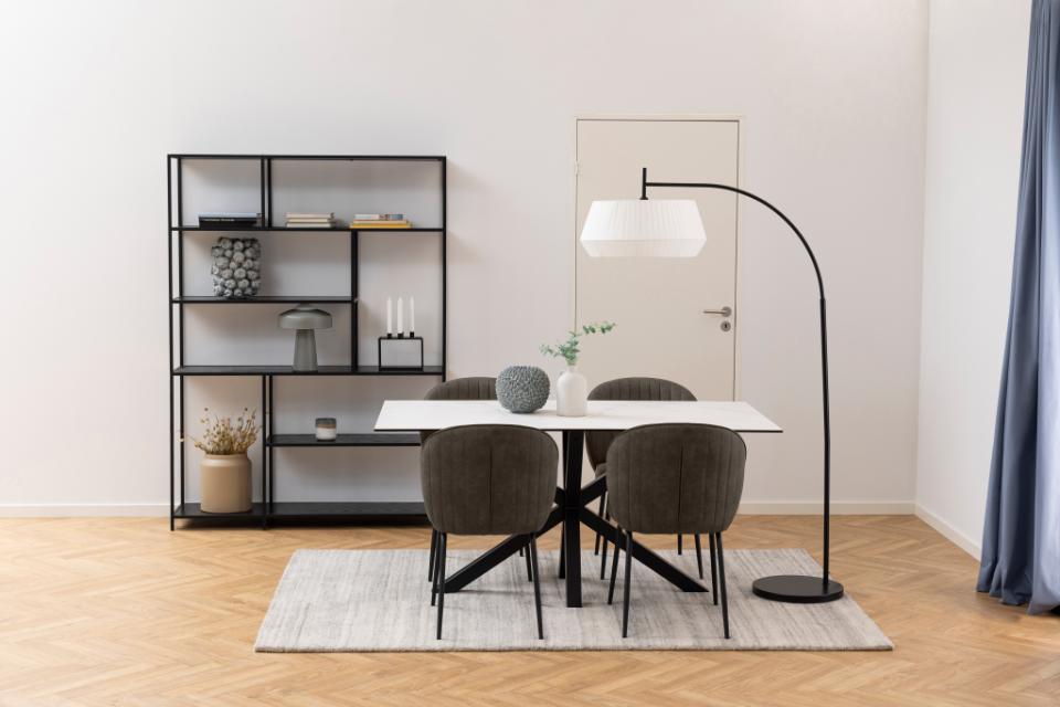 Modern dining room with a table, chairs, and decorative items.