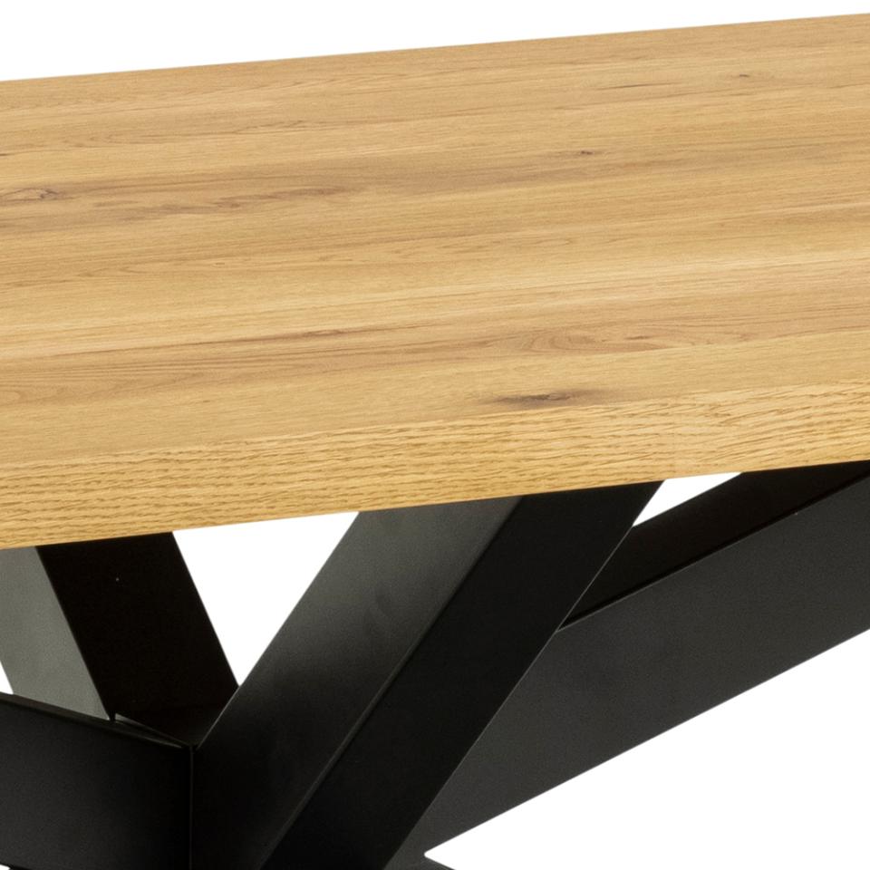 Close-up of a light oak wood tabletop with a black metal geometric base on a white background.