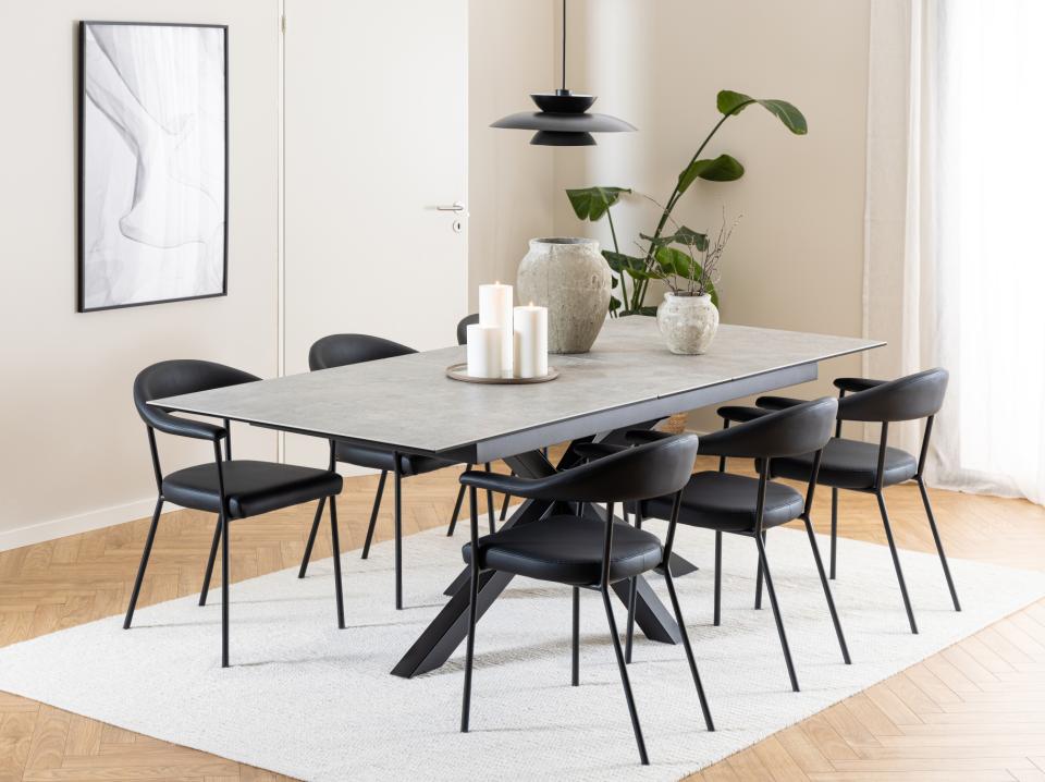 Dining room with a modern table and chairs in a well-lit room.