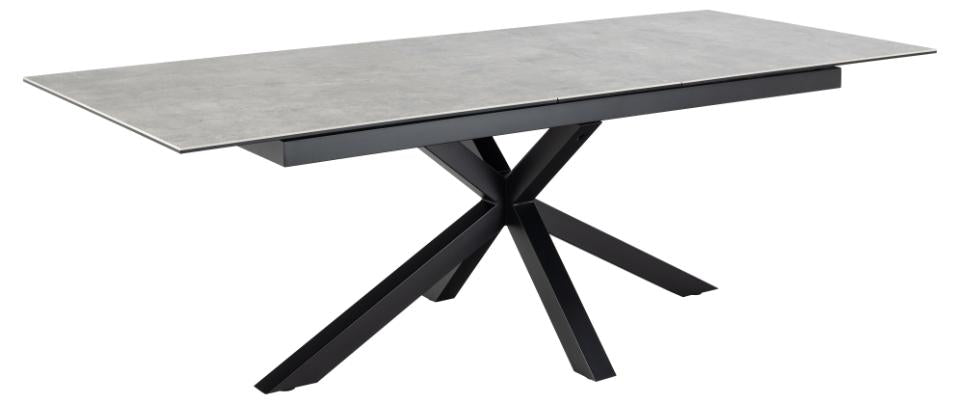 Dining table with gray surface and black metal legs on a white background