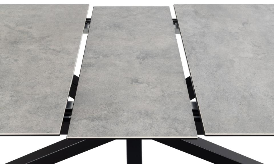 A modern extendable rectangular table with three grey ceramic top panels and a black metal frame, shown on a white background.