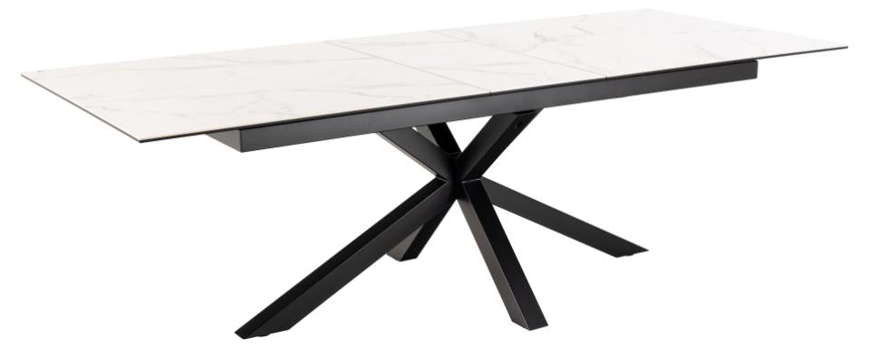 Modern dining table with white top and black metal legs on a white background