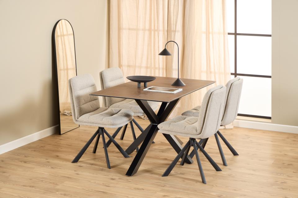 Dining area with a wooden table and four chairs in a well-lit room.