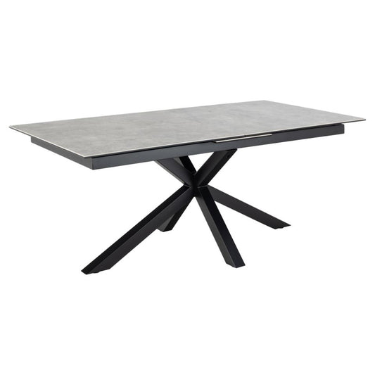 A rectangular grey ceramic dining table with a black metal cross base and extension leaves.