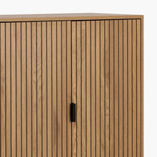 Load image into Gallery viewer, Wooden cabinet with vertical slats and a black handle on a white background

