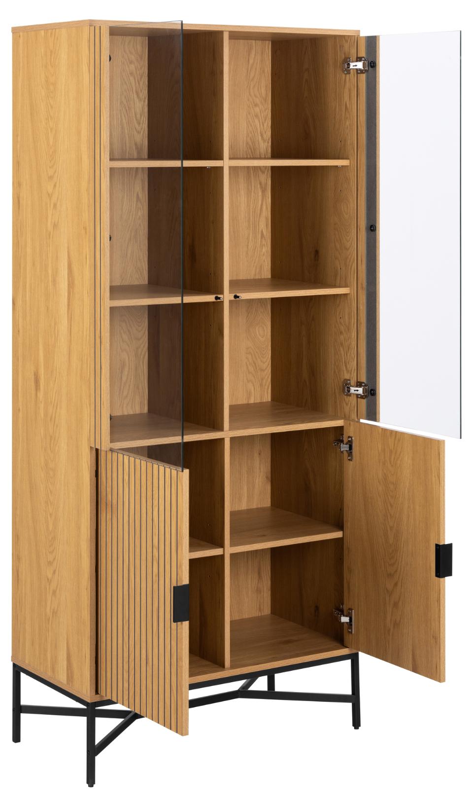 A tall wooden storage cabinet with a warm oak finish, featuring multiple open shelves, a slatted door on the lower left, and an open right door showing the interior. The cabinet stands on black metal legs against a plain white background.