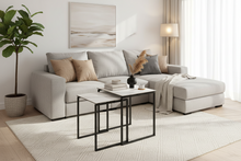 Load image into Gallery viewer, Modern living room with a gray sectional sofa, coffee table, and decorative items.
