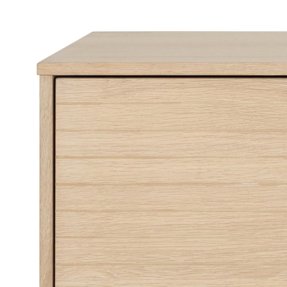 Close-up of a wooden sideboard with a light finish on a white background