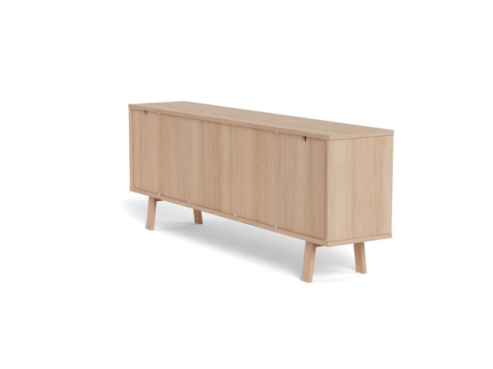 A mid-century modern sideboard cabinet in light natural oak wood, featuring six vertical-panel doors and tapered legs, shown from behind on a plain white background.