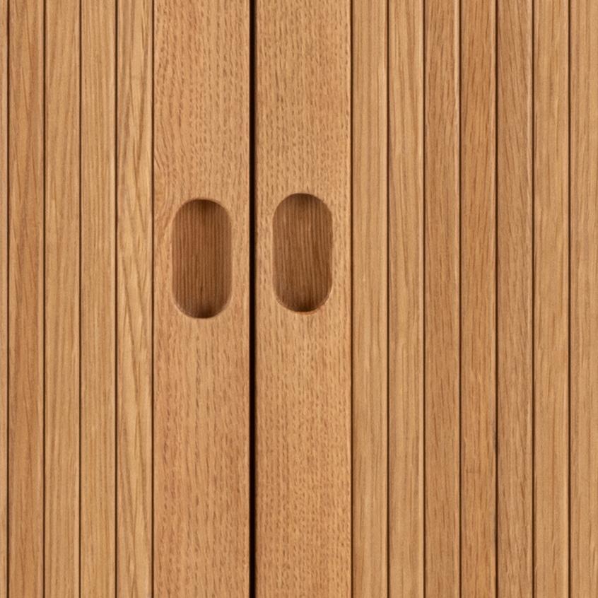 Close-up of wooden panel with two oval cutouts