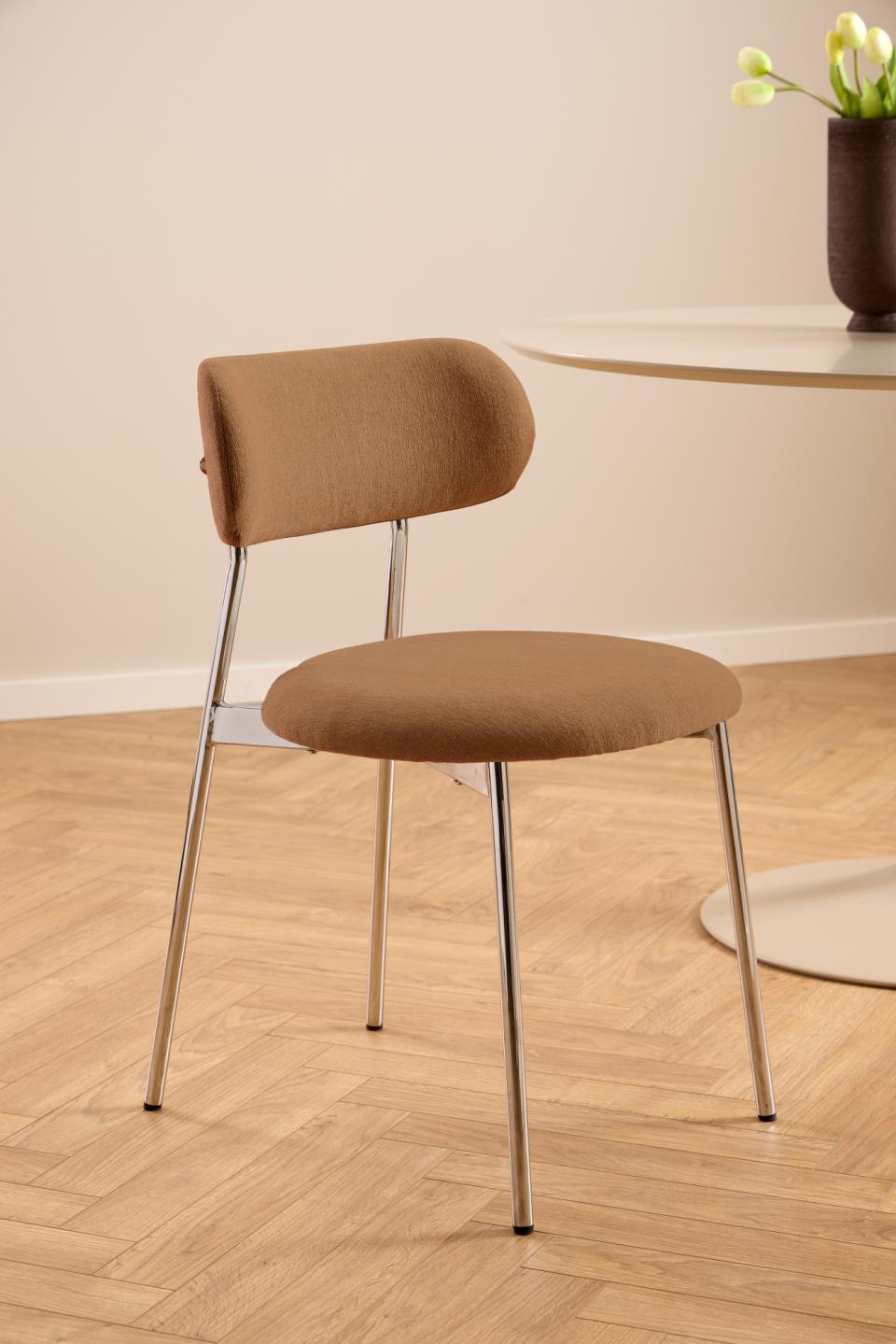 Brown chair with metal legs on a wooden floor