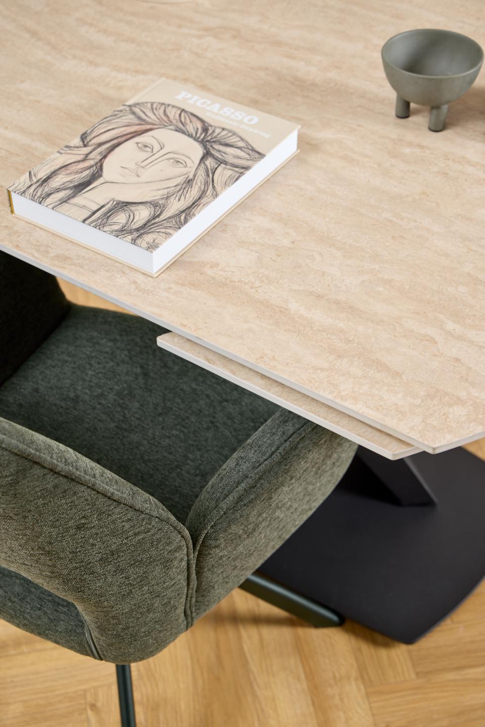 ceramic dining table with a chair and a book on a wooden floor