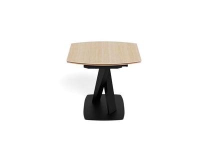A modern extendable dining table with a light beige ceramic hexagonal top and a black metal A-frame pedestal base, shown on a solid white background.